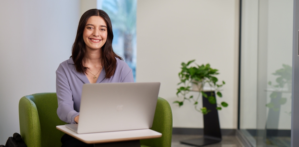 Thunderbird student Grecia Cubillas sits with her laptop at global headquarters