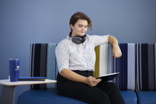 Thunderbird student sits in the 3rd floor student lounge