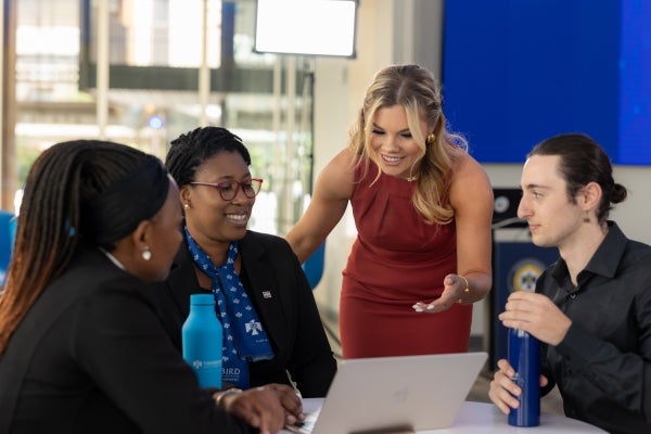 Image of Thunderbird students chatting and smiling in the Haas Digital Global Forum