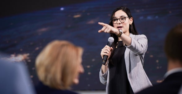 Image of a Thunderbird student giving a presentation to a crowd in the Global Events Forum.