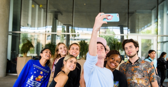 Undergraduate students take a group selfie