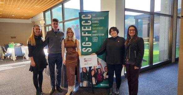 Image of the group standing in front of the SG-FECC banner.