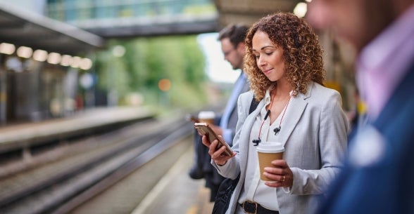 A commuter checks her phone