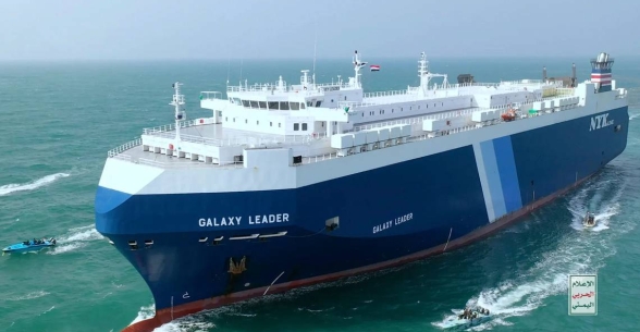 This photo released by the Houthi Media Center shows Houthi escort the cargo ship Galaxy Leader on Sunday, Nov. 19, 2023. Yemen’s Houthis have seized the ship in the Red Sea off the coast of Yemen after threatening to seize all vessels owned by Israeli companies. (Houthi Media Center via AP) AP