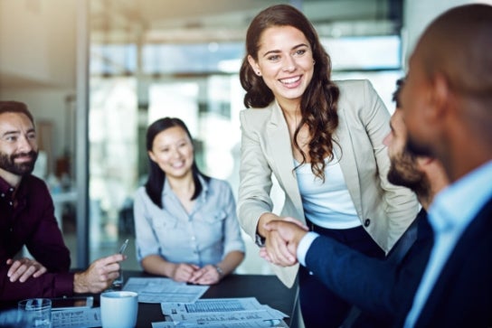 Business executives shaking hands during a meeting